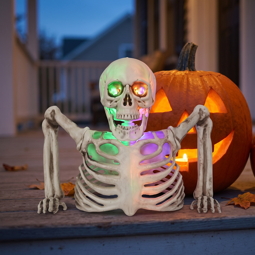 Glowing Skeleton Prop half-body skeleton with colored lights next to a pumpkin