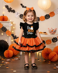 Girl wearing a ghost and pumpkin print top and skirt set at a Halloween party